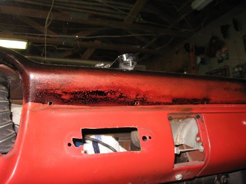1966 Ford F-100 - The dashboard of a vehicle is shown, with visible signs of wear and modification, including cutouts and a textured surface.
