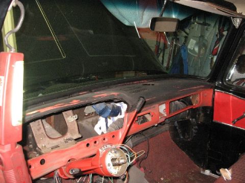 1966 Ford F-100 - The interior of a 1966 Ford F-100 shows a red dashboard with exposed wiring and parts removed for a repaint.
