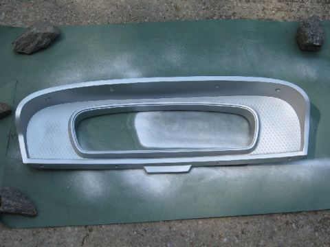 1966 Ford F-100 - Instrument cluster bezel being prepped for painting, held down by rocks.