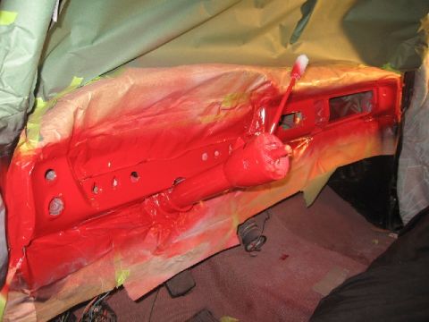 1966 Ford F-100 - The interior of a 1966 Ford F-100 is shown with the dashboard and steering column covered in red paint.