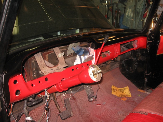 1966 Ford F-100 dashboard with red painted dash and steering column, wiring visible