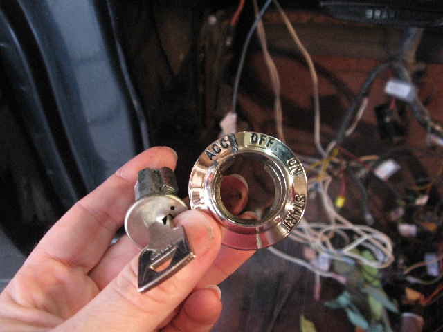 Ignition switch with ACC, OFF, ON, START labels and key held in hand