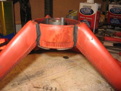 1966 Ford F-100 - A red steering wheel hub is shown on a workbench, surrounded by restoration supplies.