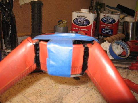 1966 Ford F-100 - A partially disassembled steering wheel part, taped with blue masking tape, sits on a workbench with cans of lacquer thinner in the backgro…