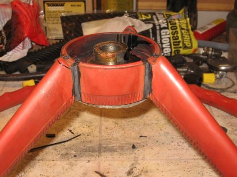 1966 Ford F-100 - Close-up of a disassembled red steering wheel part on a workbench.