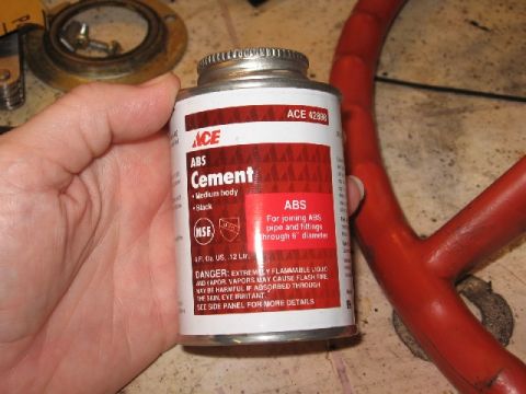 1966 Ford F-100 - A can of ACE ABS Cement is held in a hand, with a red steering wheel component visible in the background.