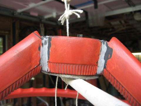 1966 Ford F-100 - This is a close-up of a red steering wheel hub, showing damage and repair work.