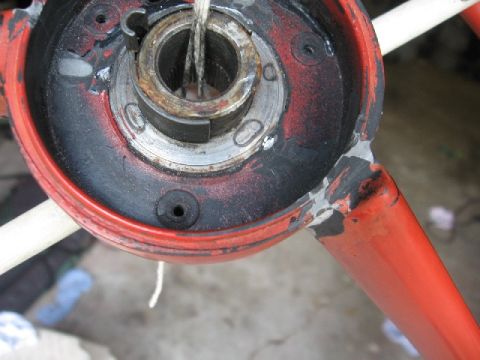 1966 Ford F-100 - Close-up of a red steering column assembly, likely undergoing restoration or repair.