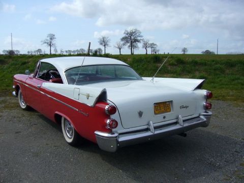 1991 Ford Crown Victoria - This two-tone red and white 1956 Dodge Coronet coupe is shown from the rear 3/4 angle.