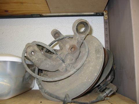 1993 Ford Taurus - This is a spare automotive part, likely a suspension knuckle and brake rotor assembly.