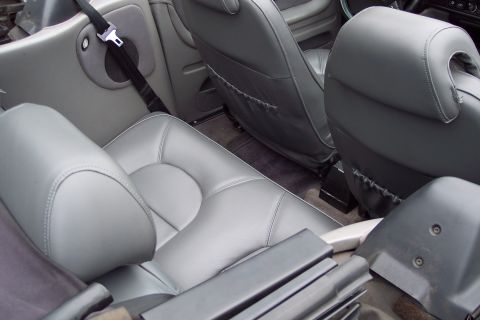 2001 Ford Crown Victoria - Interior view of gray leather seats and seatbelt.