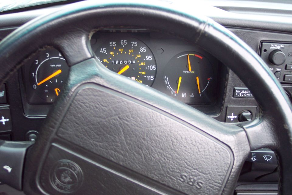 Interior dashboard of a 1992 Saab 900 Turbo Convertible showing gauges and steering wheel