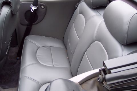 2001 Ford Crown Victoria - Interior view of gray leather rear seats and a seatbelt in a convertible.