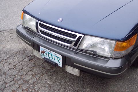 2001 Ford Crown Victoria - Front view of a blue Saab, its grille, headlights, and license plate.