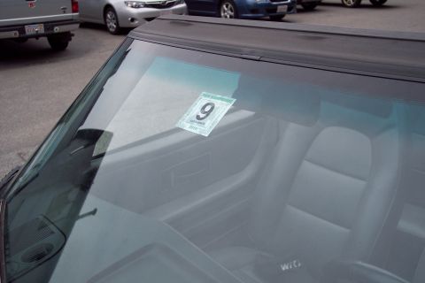 2001 Ford Crown Victoria - A car's interior is seen through the windshield, which displays a September 2010 inspection sticker.