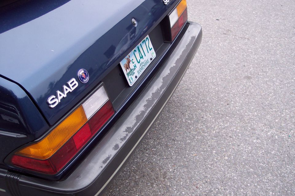 Dark blue Saab 900 rear bumper and taillight with a New Hampshire license plate