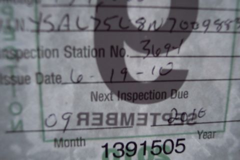 2001 Ford Crown Victoria - A vehicle inspection document shows handwritten details including inspection station number and issue date.