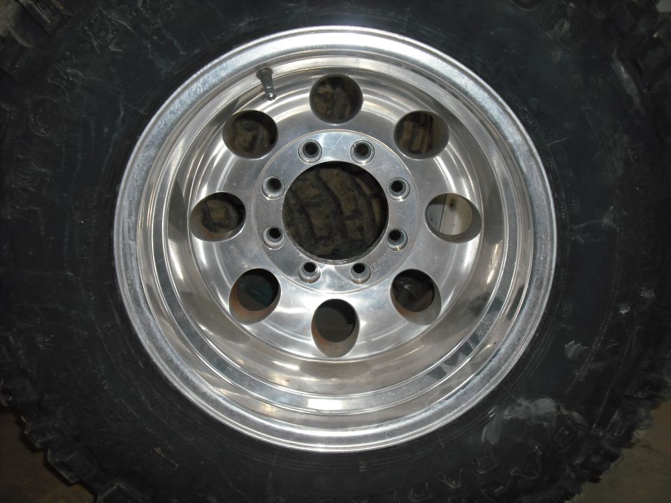 Aluminum alloy wheel with eight lug holes and a large tire
