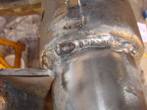 1992 Ford Bronco - Close-up view of a heavily welded metal component, likely part of a vehicle's axle assembly.