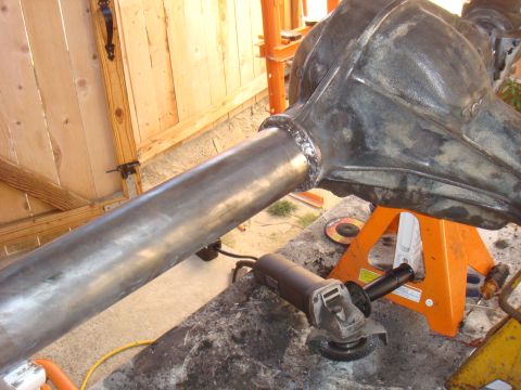 1992 Ford Bronco - An axle housing is being worked on, with welding and an angle grinder visible.