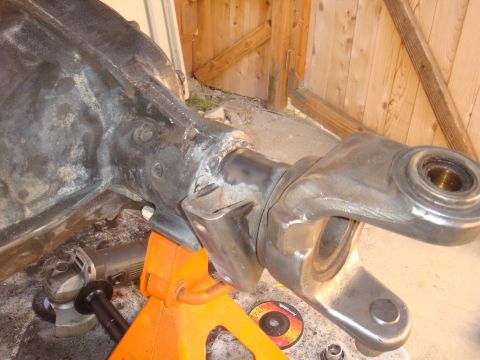 1992 Ford Bronco - A differential axle housing is shown on a jack stand, with tools for modification present.
