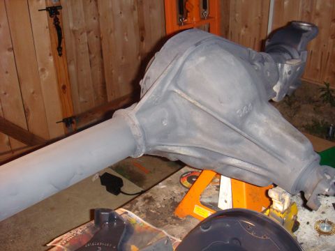 1992 Ford Bronco - A rear axle assembly is shown supported by jack stands in front of a wooden fence.