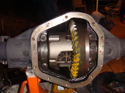 1992 Ford Bronco - Open differential housing with visible ring and pinion gears, supported by a jack stand.