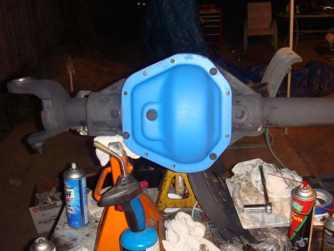1992 Ford Bronco - A vehicle's rear axle assembly is shown with a freshly painted blue differential cover and various tools.