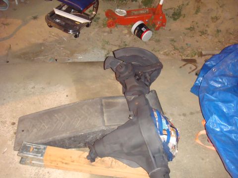 1992 Ford Bronco - Rear axle assembly, possibly from a Ford Bronco, resting on blocks in a garage.