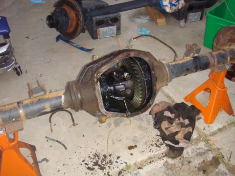 1992 Ford Bronco - Differential axle assembly, likely undergoing maintenance or repair, is shown on jack stands with the differential cover removed.