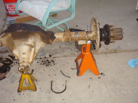 1992 Ford Bronco - A rear axle assembly, likely from a truck or SUV, is supported by jack stands on a concrete surface.