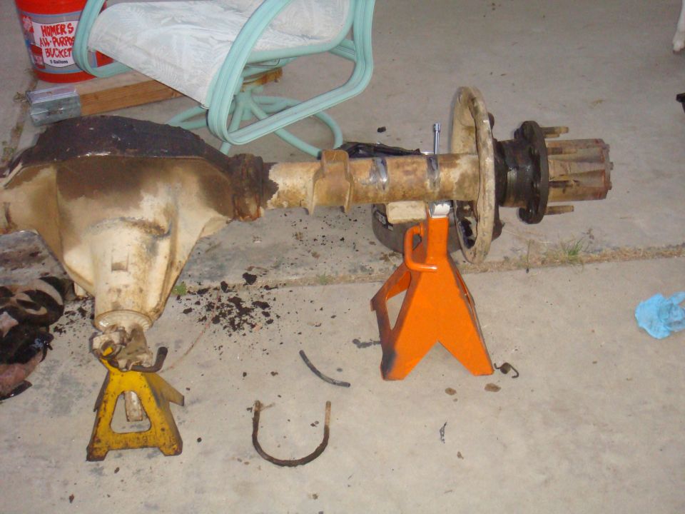 Rear axle assembly on jack stands, showing differential housing and hub assembly