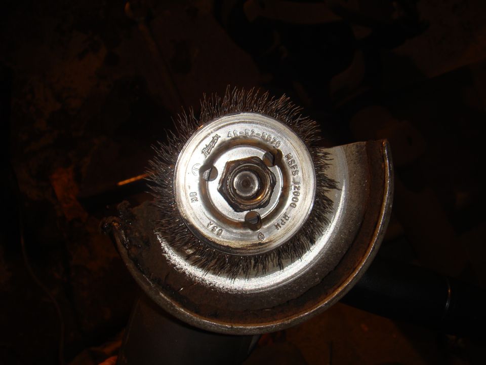 Wire wheel brush on angle grinder, with text indicating 12000 RPM