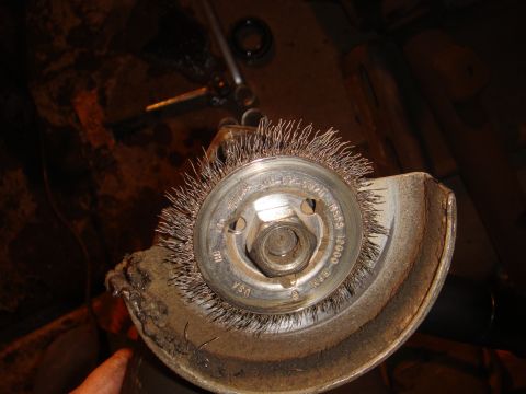1992 Ford Bronco - A close-up view of a wire wheel brush on an angle grinder, indicating a part used for cleaning or restoration.