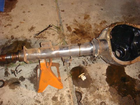 1992 Ford Bronco - Differential axle assembly, likely from a truck or SUV, resting on an orange jack stand on a concrete surface.