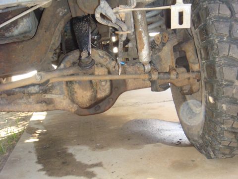 1992 Ford Bronco - Close-up view of the front axle and suspension system of a vehicle, showing various mechanical parts.