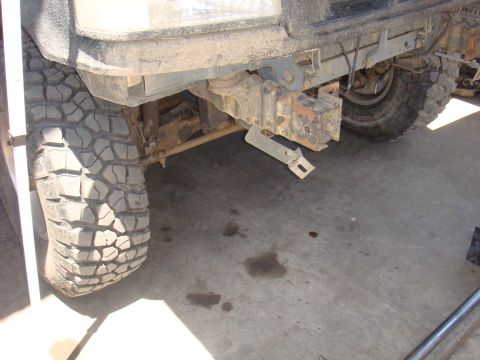 1992 Ford Bronco - The front bumper and tire of a vehicle are shown, with evidence of off-road use and potential modifications.