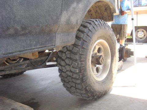 1992 Ford Bronco - A vehicle's rear axle and large off-road tire are shown, possibly undergoing maintenance or modification.