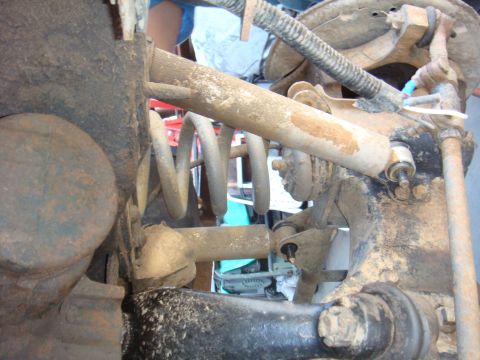 1992 Ford Bronco - Close-up view of the rear axle suspension system, showing the coil spring and shock absorber.