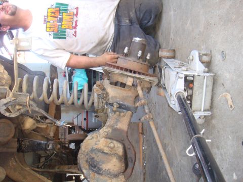 1992 Ford Bronco - Front axle assembly and coil spring being worked on.