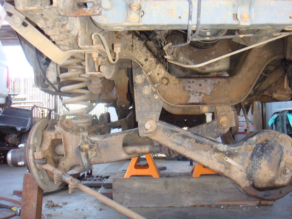 1992 Ford Bronco rear axle assembly on jack stands, showing suspension components and differential