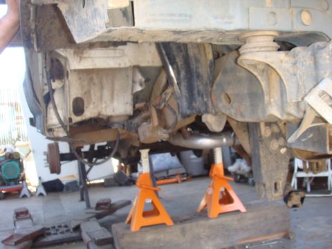 1992 Ford Bronco - Vehicle frame and suspension components are visible while the vehicle is supported by jack stands.