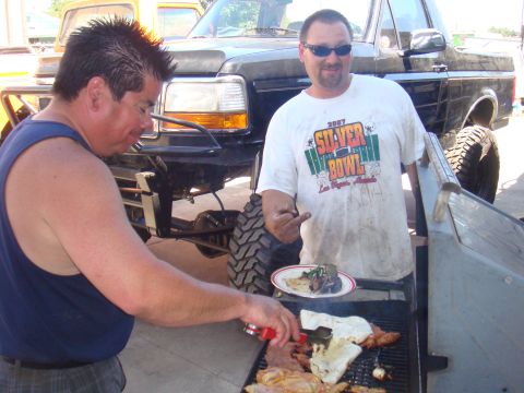 1992 Ford Bronco - Two men grill food in front of a modified 1992 Ford Bronco.