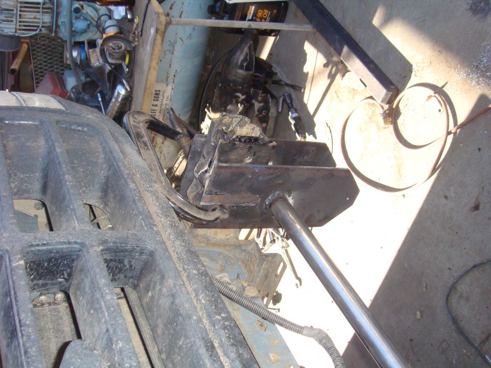 Engine bay with custom metal fabrication and engine components visible