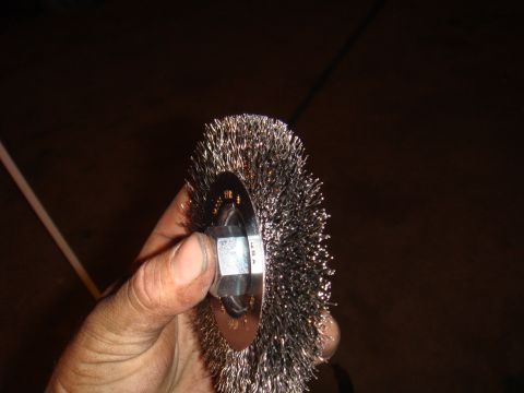 1992 Ford Bronco - Wire wheel brush held by hand, with visible text indicating it is made in the USA.