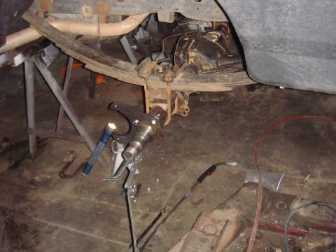 1992 Ford Bronco - Vehicle axle assembly and tools in a workshop setting.