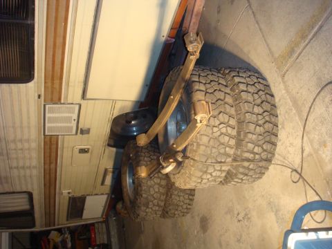 1992 Ford Bronco - Leaf springs and large off-road tires are visible, suggesting a vehicle undergoing modifications or repairs.