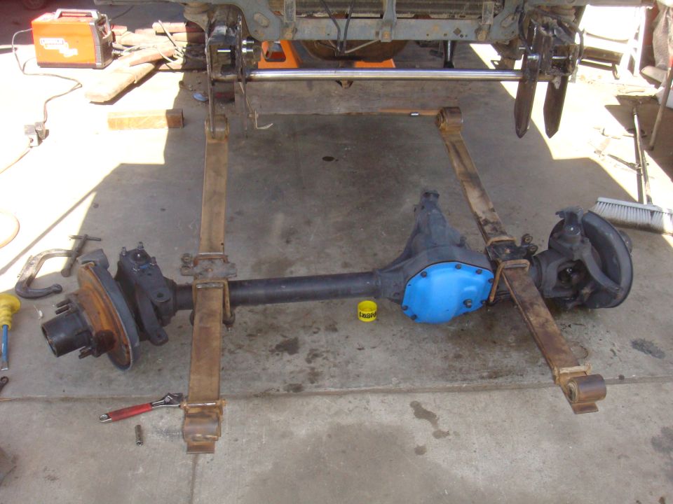 Front axle assembly with blue differential cover and leaf springs