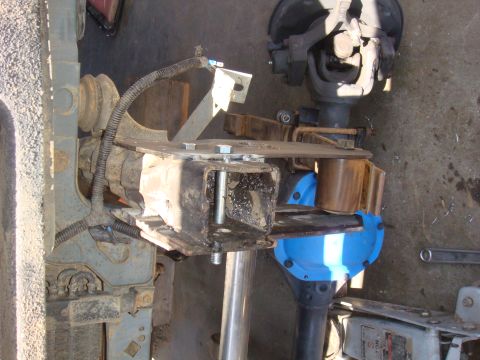 1992 Ford Bronco - Close-up view of vehicle axle components, including a blue differential cover and fabricated metal brackets.