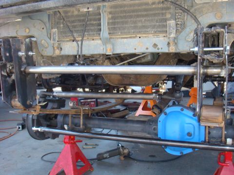 1992 Ford Bronco - Vehicle undercarriage shows suspension modifications and a bright blue differential cover.